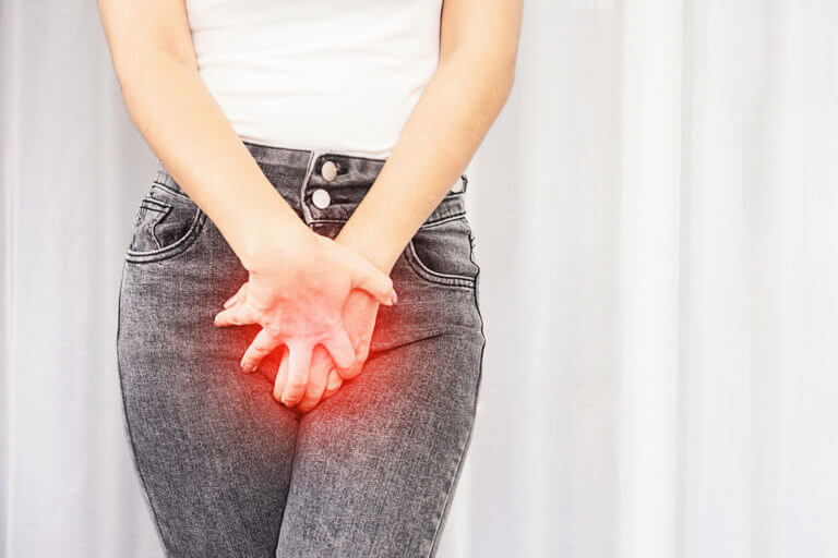 A woman suffering from pain and an itchy crotch is holding her burning vaginal area, suggesting a possible STD.